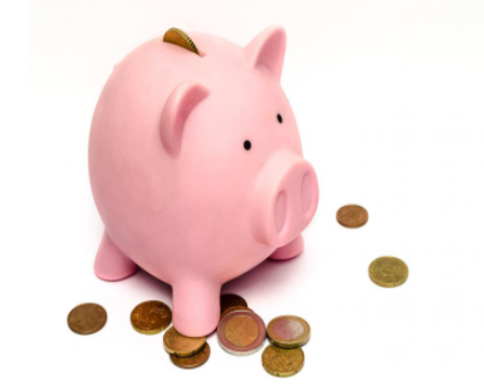 Pink Piggy Bank on Top of Coin Pile SkitterPhoto, CC BY 00